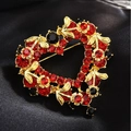 Macro shot of a red heart-shaped brooch with sparkling rhinestones on black silk - Red Heart-A