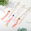 Detailed view of three cat teaser wands with colorful plush balls and ribbon tassels - Pom Pom Ribbon