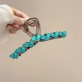 Transparent brown acrylic hair claw clip featuring turquoise green heart accent in hand - Large 13cm / Blue