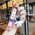 Pink silicone astronaut keychain with matching wrist strap and cartoon charms - Pink