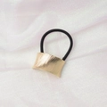 Detailed shot of gold brushed metal cuff on a black elastic hair tie for ponytails - Curved Brushed (1) / Gold
