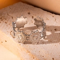 Elegant floral pattern open ring in silver finish displayed on a natural stone base - Steel Color 71