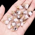 Natural white quartz geode pendants with gold plated edges held in hand for DIY jewelry - Moonstone