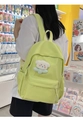 Neon yellow canvas backpack with white bear pendant shown on model in casual setting - No Pendant / Green