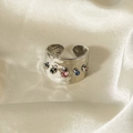 Wide textured gold ring featuring five colorful round-cut gemstones on satin background - 5-Color Zircon Hammered Ring