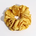 Detail of a large golden satin scrunchie showing glossy silk texture and pleated fabric folds - Ginger Yellow Large