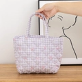 Close-up of lavender quilted floral tote bag with pink bow pattern and diamond stitching - Purple Grid with Bow