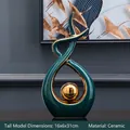 Modern abstract green and gold ceramic ornament with a streamlined circular design - 16x6x31cm / Green Gold (Tall)