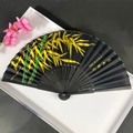 Classic folding fan with black silk and green bamboo pattern on carved bamboo ribs - Gold & Green Bamboo on Black Background (Women's Fan Style - 88)