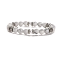 Detailed macro shot of white turquoise beads with vintage silver spacers on elastic bracelet - Howlite