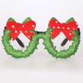 Close-up of glittery green Christmas party glasses frame with red felt bow decoration - Bowknot Style