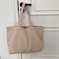 Detail of the thick woven texture and handle of a minimalist beige canvas tote bag - Solid Flesh Pink