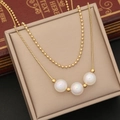 Golden layered necklace with pearls and heart pendant displayed on a beige leather stand - Double Layer Ball Snake Chain Triple Pearl Style(2#)