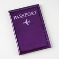 Detail of purple metallic passport cover with cracked texture and white lettering - Purple