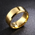 Macro shot of polished gold beveled edge stainless steel ring on black textured surface - US 6 / 8mm / Gold