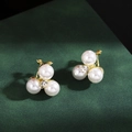 Elegant gold earrings featuring three white pearls and a central crystal diamond stud - Triple Pearl Combo Rhinestone Studs