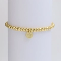 Detailed view of golden beaded bracelet featuring a round letter W initial pendant - Letter W (DB240603-W)