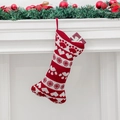 Red and white knitted bone-shaped Christmas stocking with heart patterns hanging on fireplace - Knitted Heart Paw Style / Heart and Paw Pattern