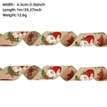 Detail view of 6.5cm wide burlap Christmas ribbon with gnome print and wired edges - Khaki Gnome / 1m