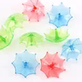 Close-up of colorful miniature plastic umbrellas with cartoon silhouettes and matte finish - Umbrella Spinning Top