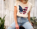 Beige Independence Day T-shirt featuring patriotic butterfly graphic with floral detail - Khaki / XS