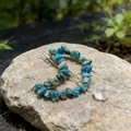 Detailed view of silver crescent moon hair clip with blue-green natural crystal stones - Blue Labradorite
