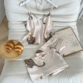 Champagne leopard print satin pajama set with V-neck camisole and shorts on sofa - S / Champagne