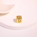Macro shot of gold cubic bead with rhinestone letter D for DIY jewelry making - Letter D