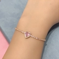 Close-up of heart-shaped pink gemstone bracelet with bow-knot design and zircons - Heart - Gold