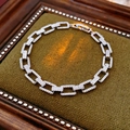 Silver paperclip link bracelet with pavé cubic zirconia on green velvet background - Paperclip Square Link Design / Silver