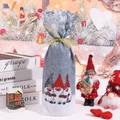 Detailed view of grey and white Christmas wine bottle bag with festive gnome print and gold ribbon - Gray