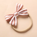 Detail of soft nylon baby headband with a striped bow and premium fabric texture - Pink White Stripes
