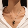 Close-up of gothic bronze skull pendant necklace worn by a model in soft lighting - Antique Bronze Vintage Skull Pendant Necklace (32) / Antique Bronze