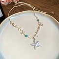 Detail view of a shell and starfish necklace on a ceramic plate with coastal vibes - 13# Wax Rope Crystal Conch Starfish Pendant Necklace