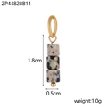 Detailed macro shot of natural stone bead pendant with gold metal hardware for jewelry DIY - Dalmatian Stone Color