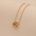 Detailed close-up of a gold-plated letter G pendant necklace with sparkling crystal inlay - Letter G
