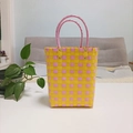 Detail of pink and yellow checkered woven tote bag with durable tube handles and metal rivets - Large / Yellow-Pink