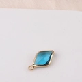 Detailed view of a blue rhombus crystal charm with golden copper frame for jewelry making - Blue (13#)