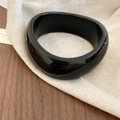 Minimalist thick irregular black acrylic resin open bangle with a glossy mirror finish - Black