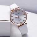 Macro detail of rose gold quartz watch with Roman numerals and sparkling crystals - White