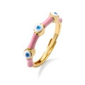 Detailed shot of gold open ring with pink enamel finish and blue evil eye charms - Pink