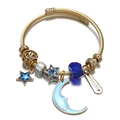 Detail of golden steel wire bangle with blue moon, star charms and crystal beads - Moon