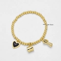 Pulsera elástica de cuentas doradas 4mm con corazón esmaltado negro y dijes café - Negro