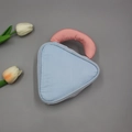Blue quilted makeup bag with pink padded handle in a minimalist product display - Small / Blue