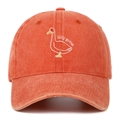Detail of silly goose embroidery on washed orange cotton baseball cap with distressed brim - Orange
