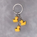 Cute yellow resin duck keychain featuring three 3D duckling pendants on a silver metal ring - 3-Piece Set / Yellow