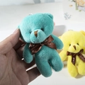 Detail of a teal plush teddy bear keychain with a brown Love ribbon and metal link chain - Bright Green