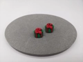 Macro detail of 3D green Christmas gift box stud earrings with red ribbon on grey base - Gift Box