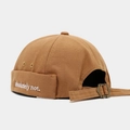 Detail of khaki miki hat with 'absolutely not' embroidery and adjustable metal buckle strap - Caramel color
