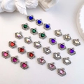 Macro shot of crown-shaped nail art charms with colorful heart rhinestones and alloy detail - Silver-Mixed Style